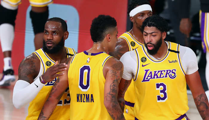 Los Angeles Lakers forward LeBron James (23) controls the ball against Portland Trail Blazers guard Gary Trent Jr. (left) during the first half of a NBA basketball first round playoff game